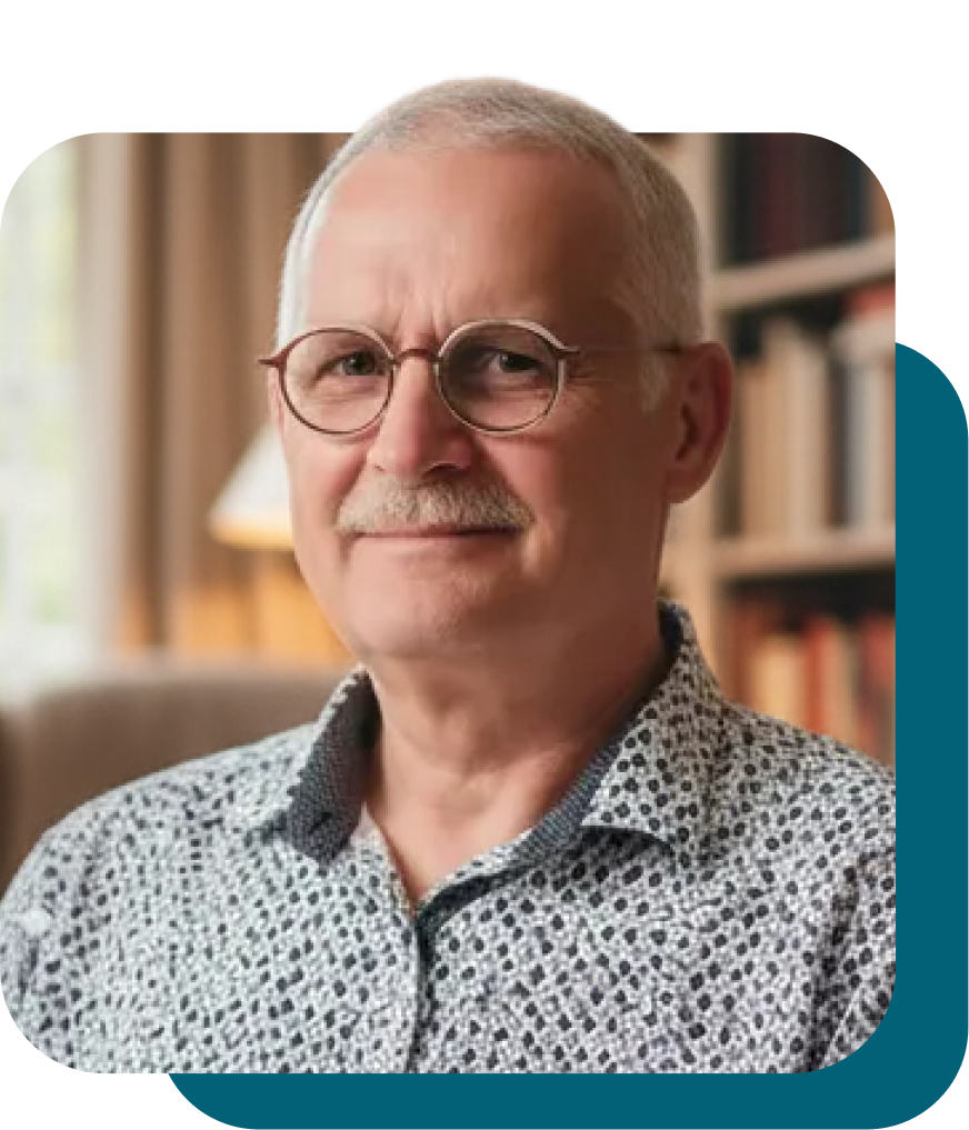 Homme souriant avec lunettes et chemise à motifs.